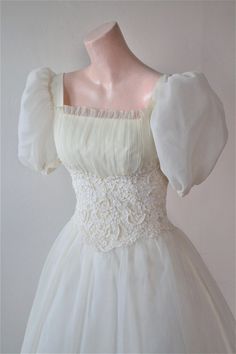 a white dress with puffy sleeves on a mannequin