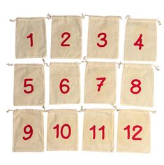 the numbers are laid out in rows on linen drawstrings with red thread