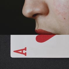 a close up of a person's face with a card in front of them