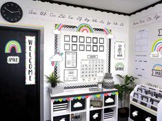 a white room with black and white decor on the wall next to a large clock