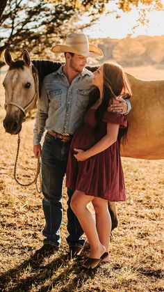 a man and woman standing next to a horse