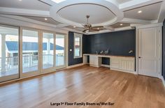 an empty living room with blue walls and wood floors