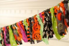 a row of halloween scarves hanging on a wall