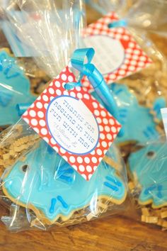 some cookies are in plastic bags with tags on the top and bottom one is blue