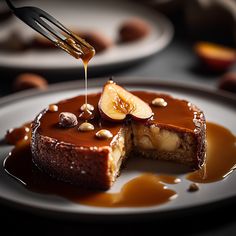 a piece of cake is being drizzled with caramel sauce and topped with sliced apples