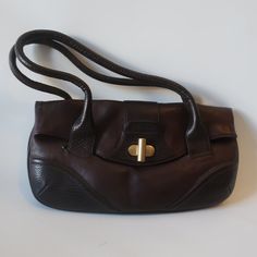 Nwd Womens Kenneth Cole Dark Brown Leather Shoulder Handbag * Color: Dark Brown Gold-Toned Hardware Flap W/ Twist Lock Closure 1- Main Compartment 1- Interior Zipper Pocket 1- Front Slip Pocket Keychain Hook Double Shoulder Strap Handle Material: Leather Measurements: Depth: 1.4" Height: 8.2" Base Width: 15.5" Strap Drop: 7.8" Includes Original Dust Bag Nwd, The Flap Where The Straps Lie Have Indent Marks On The Flap (See Pics) Otherwise; New With Defect. (Bag Uu).. Jms_farl(Up)-4** Brown Bags With Fold Over Clasp For Everyday, Office Brown Satchel With Fold Over Clasp, Brown Bag With Fold Over Clasp For Daily Use, Elegant Faux Leather Bags With Snap Closure, Trendy Formal Bag With Snap Closure, Office Brown Shoulder Bag With Snap Closure, Brown Office Bag With Snap Closure, Brown Clutch Bag With Snap Closure, Leather Tote Shoulder Bag With Fold Over Clasp