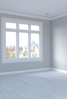 an empty room with white floors and windows