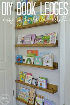 three wooden shelves filled with children's books in a white walled nursery room next to a door