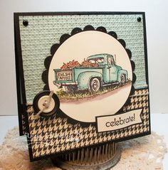 a close up of a card with a truck on the front and a button in the middle