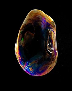 an image of soap bubbles floating in the air with colors changing from yellow to blue