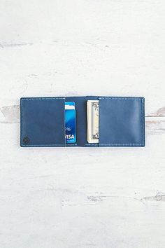 Our newest bifold leather wallet, handmade in our studio, features four card slots (two inside, two outside) and a billfold pocket. This slim design can fit up to 10+ cards and cash comfortably. This durable buffalo calf leather has a smooth finish and will gradually darken and patina beautifully overtime. **Contents** * 100% Genuine Korba Buffalo Calf Leather * Vegetable Tanned * 4 card slots + billfold pocket * Handmade **Care/Import** * Made in the USA **Dimensions** * Measures approximately Classic Blue Trifold Wallet For Everyday Use, Classic Blue Trifold Wallet With Rfid Blocking, Blue Leather Trifold Wallet With Card Slots, Blue Leather Wallet With Rfid Blocking, Blue Trifold Wallet With Coin Pocket, Classic Blue Trifold Wallet With Card Slots, Blue Trifold Wallet With Interior Card Slots, Everyday Blue Trifold Wallet With Coin Pocket, Blue Bifold Wallet For Everyday Use