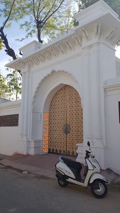 a scooter parked in front of a white building