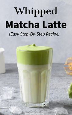 whipped matcha latte recipe in a glass with ice cubes on the side