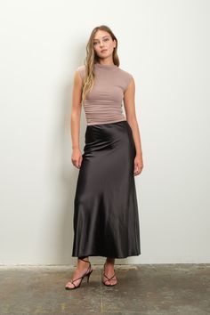 Expertly crafted with a high waist and elasticized waistband, this midi skirt offers a flattering A-line silhouette. The satin texture adds a touch of elegance to this versatile skirt, while the solid color allows for easy styling. Made from a comfortable and durable blend of polyester and spandex, perfect for any occasion. Midi Skirt Satin, Denim Short Romper, Slip Midi Skirt, Satin Slip Skirt, Skirt Satin, Satin Texture, Athleisure Tops, Mini Sundress, Boho Luxe