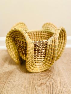 a woven basket sitting on top of a wooden floor