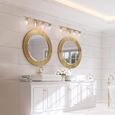 a bathroom with two sinks, mirrors and a tub in the middle of the room