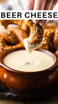 a person dipping cheese into a bowl with pretzels in the background and text overlay reading beer cheese