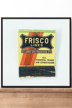 a box of frisco sitting on top of a wooden shelf