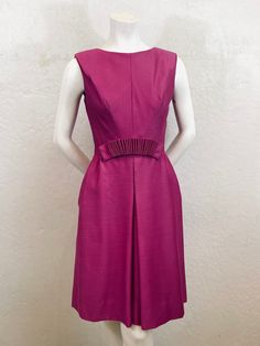 What an elegant cocktail dress! - Late 1950's to early 1960's - "Suzy Perette" label - Rayon Blend - Satin lining - Cocktail dress / party dress - Raspberry color - Sleeveless - Small pleat on each shoulder seam - Bra strap holders inside - Metal Zipper - Hook and eye above zipper - Fitted bodice - A-line skirt with front pleat - Accordion fabric embellishment at waist - Below knee length Measurements - Shoulder to Shoulder: 15" - Bust: 35" - Waist: 25"  - Hips: 38" - Shoulder to Waist: 14 1/2" - Waist to hem: 22 1/2 Condition: two extremely faint small stains on the front of the skirt near the waist (see picture #10) - this dress has been dry cleaned  Please ensure fit before purchasing. All sales are final. No returns or exchanges. Please contact us if you need more information. Shipping 1960s Fashion Women, 1950s Fashion Women, 1960s Dresses, 1960 Fashion, Elegant Cocktail Dress, Fabric Embellishment, Raspberry Color, Bra Strap, 60s Mod