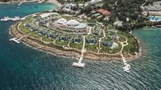 an aerial view of the resort and its surrounding area, with boats in the water