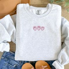 Cozy up in style with this charming embroidered sweatshirt featuring a trio of delicately stitched strawberries in a lovely pink hue. Perfect for casual outings or lounging at home, this sweatshirt combines comfort with a touch of whimsy, making it a unique addition to any wardrobe. The soft material provides warmth and comfort, while the adorable berry design adds a playful touch. A great gift for fruit lovers or anyone who appreciates unique, handcrafted apparel. ⇒ PRODUCT DETAILS - Crewneck S Coquette Strawberry, Embroidered Strawberry, Strawberry T Shirt, Fruit Embroidery, Pink Cowboy Hat, Men Crewneck, Chapeau Cowboy, Embroidery Sweater, Women Sweatshirt