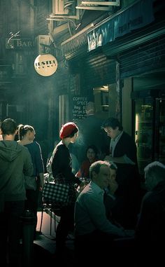 a group of people sitting at tables in a restaurant