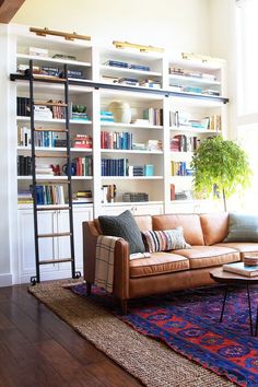 a living room filled with furniture and bookshelves