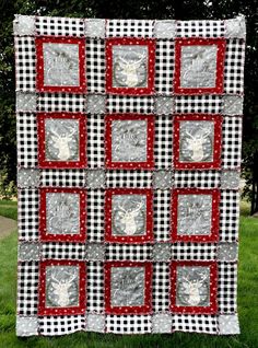 a black and white checkered quilt with red squares on the bottom, an image of a deer head