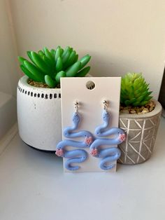 Gorgeous pastel snake earrings handmade from polymer clay. Made with stainless steel jewellery and comes with both stainless steel and silicone stoppers. max width: 3cm. length: 6.5cm. Pink Snake, Snake Earrings, Rose Pastel, Earrings Polymer Clay, Stainless Steel Jewelry, Pastel Blue, Earrings Handmade, Jewelry Earrings Dangle, Polymer Clay