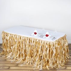 a table with two candles on it that is covered in burlap and fringe