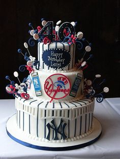 a three tiered cake with baseball themed decorations on it's side and the number forty