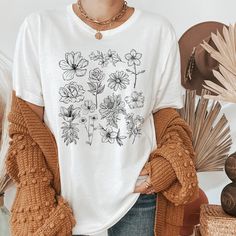 These cute cottagecore shirts feature a variety of vintage collages. If you are into cottagecore, goblincore, dark academia, fairycore, and botanical shirts then this is the perfect section for you. These trendy designs are perfect gifts for women and men, perfect for nature lovers, vegans, and plant lovers. Cottagecore is the perfect place for those that want simple living. SHIRT BRAND AND SIZING DETAILS If you love super soft, lightweight, extremely comfy shirts then you will absolutely love o Clothing Dark Academia, Botanical Tshirt, Frog And Mushroom, Floral Tshirt, Cute Cottagecore, Botanical Shirt, Ladies Shirts, Shirt Print Design, Comfy Shirts