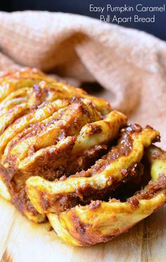 an easy pumpkin caramel pull apart bread on a cutting board with a cloth in the background