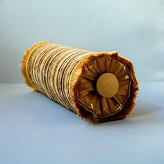 a roll of brown paper with a hole in the middle on a blue surface,