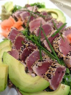 tuna and avocado salad on a white plate with sesame seed sprinkles