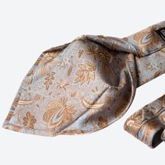 I named this tie after the Medici family, a symbol of power and refinement in Italian history. This beautiful dusty blue and steel tie features a delicate floral print in soft earthy tans. It’s the perfect choice for the man who values timeless elegance and understands the quality that comes with a handmade Italian tie. Wearing this, you’ll make a statement of sophistication and taste, just like the Medici. Details Standard Length: Approx. 3.25" x 58.5" (8 x 149cm). A classic tie width and lengt Adjustable Elegant Neckwear For Semi-formal Occasions, Elegant Adjustable Neckwear For Semi-formal Occasions, Elegant Brown Tie, Fitted Elegant Brown Neckwear, Elegant Adjustable Brown Ties, Elegant Brown Silk Neckwear, Elegant Fitted Brown Neckwear, Elegant Brown Adjustable Ties, Square Scarf Tying