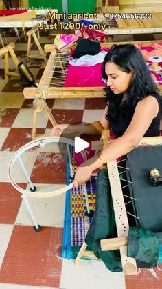 a woman sitting on top of a chair weaving