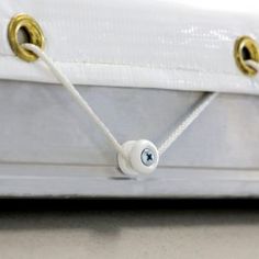 a close up of a white mattress with two gold rings on it