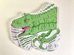 a green sticker with an image of a large alligator on it's back