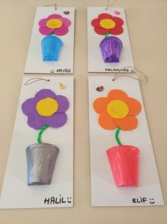 three flower crafts made from construction paper and colored pencils, each with an individual's name