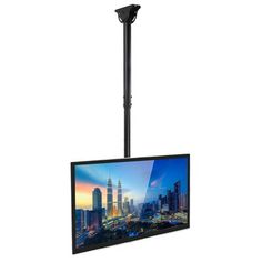 a flat screen tv mounted to the side of a pole with a cityscape in the background