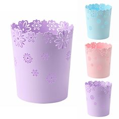 four different colors of paper cups with flowers on the inside and outside, all decorated in pastel shades