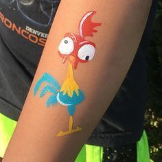 a close up of a person's arm with a tattoo on it that looks like a rooster