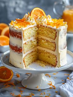 a cake with orange slices on it is cut in half and sits on a plate