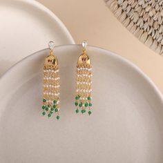 Description : Introducing our opulent gold-plated silver jhumka, featuring an exquisite hint of red enamelled paisley, a symbol of tradition and grace. The delicate pearl strands elegantly cascade down, creating a harmonious blend of sophistication, while vibrant green beads beneath add a touch of vibrancy. Elevate your ethnic ensemble with this intricately designed jhumka, perfect for adding a regal touch to your traditional attire. Product Information : Metal: 925 Silver with 1.0 microns Gold Elegant Jhumkas With Latkans For Eid, Elegant Eid Jhumkas With Latkans, Elegant Jhumkas With Dangling Beads For Festive Occasions, Elegant Festive Jhumkas With Dangling Beads, Elegant Jhumkas With Dangling Beads For Diwali, Elegant Diwali Jhumkas With Dangling Beads, Gold Jewelry With Tassels For Celebrations, Elegant Gold Plated Dangle Jhumkas, Elegant Gold Plated Jhumkas With Latkans