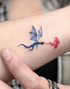 tattoo / tattoos / tattoo idea / dragon tattoo / dragon / colored tattoo / blue dragon tattoo / blue tattoo / blue and red tattoo / red tattoo Dragons Tattoo For Women, Small Dragon Tattoo Designs, Game Of Thrones Dragon Tattoo, Game Of Thrones Tattoo Ideas, Dragon Tattoo Wrist, Thestral Tattoo, Watercolor Dragon Tattoo, Blue Dragon Tattoo, Dragon Tattoo Ideas