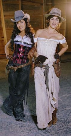 two women dressed in western clothing posing for the camera