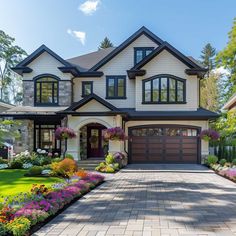 a large house with lots of flowers in the front yard