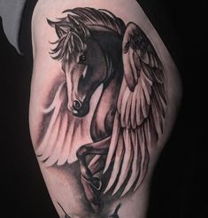 a black and white horse with wings on his arm