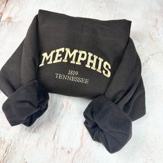 Memphis Embroidered Sweatshirt Message me for other cities! Or add your city at the personalization for custom order  -Embroidered Sweatshirt   - Unisex Sweatshirt -Jerzees brand *(Gildan or Port & Co brands may be used to fulfill any back orders that may occur) - Design is 6.8in wide for all  sweatshirt sizes  please message me for any questions. Thank you! Black Custom Embroidered Tops For College, Black Custom Embroidery Tops For College, Black Tops With Custom Embroidery For College, Sweat Shirts, Embroidered Sweatshirt, Embroidered Sweatshirts, Unisex Sweatshirt, Custom Orders, Sweat Shirt